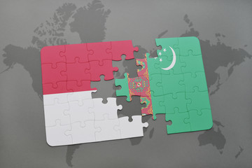 puzzle with the national flag of indonesia and turkmenistan on a world map background.