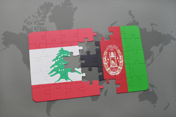 puzzle with the national flag of lebanon and afghanistan on a world map background.