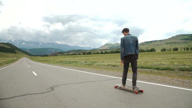 hipster man longboarding extremely action in highway.