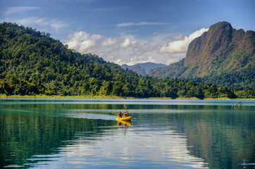 Traveler is kayaking on water in beautiful view of mountain and