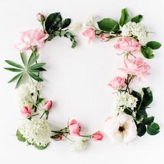 flat lay frame with pink and white roses, branches, leaves and petals isolated on white background....