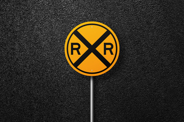 Road sign of the circular shape on a background of asphalt. Railway. The texture of the tarmac, top view.
