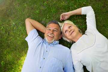 Senior couple lying on grass
