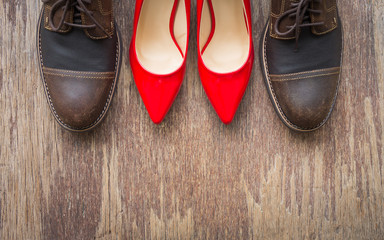 Top view, flat lay background of brown leather shoes and red high heel shoes