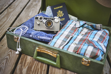 travel items including a suitcase, passport, clothing, and camera.