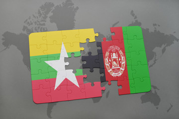 puzzle with the national flag of myanmar and afghanistan on a world map background.