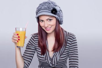 Redhead girl having an orange juice 