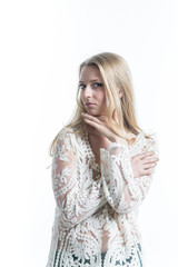Naklejka premium Beautiful Russian blonde girl on a white background in translucent blouse