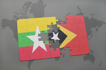 puzzle with the national flag of myanmar and east timor on a world map background.