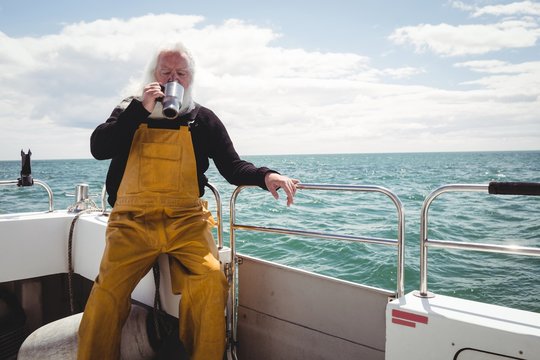 Fisherman drinking cup of coffee