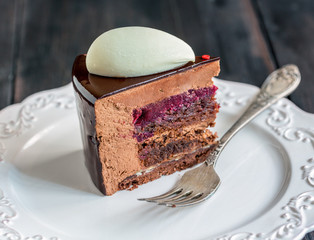 Piece of modern mousse cake with chocolate glaze.