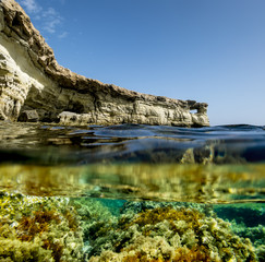 View of the cliffs and sea caves of Cape Greco from under the wa
