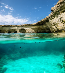 View of the cliffs and sea caves of Cape Greco from under the wa