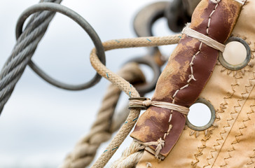 Sailing hardware and canvas sail close up detail of a vintage sailboat