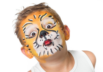 lovely adorable kid with paintings on his face as a tiger or lio © Niels