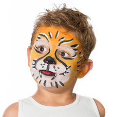 lovely adorable kid with paintings on his face as a tiger or lio