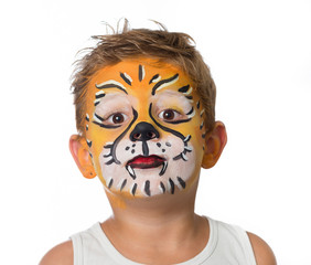 lovely adorable kid with paintings on his face as a tiger or lio
