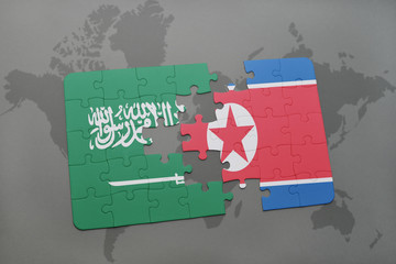 puzzle with the national flag of saudi arabia and north korea on a world map background.