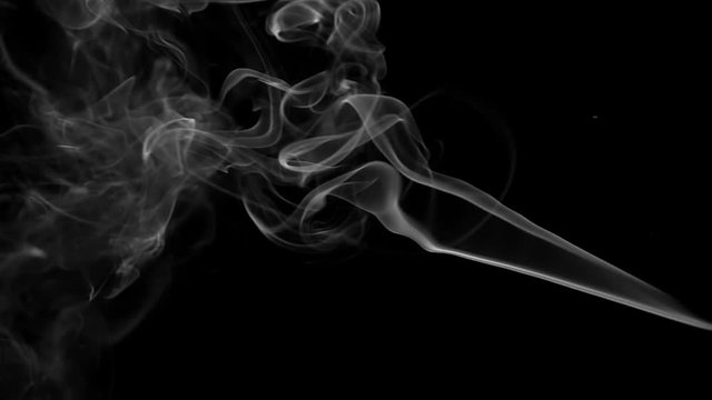 Stream of wispy smoke over a black background. Vertically Orientated Video.