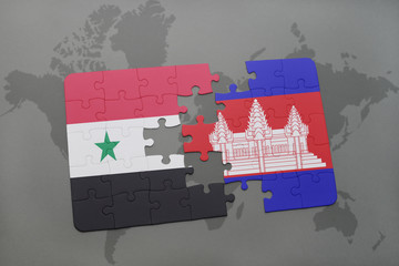 puzzle with the national flag of syria and cambodia on a world map background.