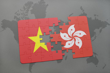 puzzle with the national flag of vietnam and hong kong on a world map background.