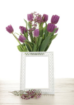 Vase of Tulip Flowers Behind a Blank Picture Frame