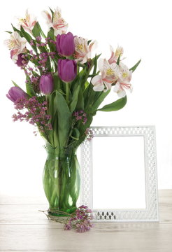 Vase of Flowers Next to Blank Picture Frame