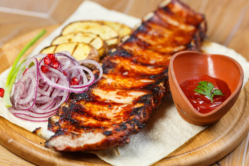 Ribs on the grill with potatoes
