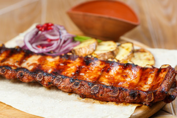 Ribs on the grill with potatoes
