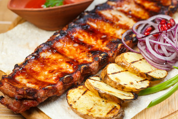 Ribs on the grill with potatoes
