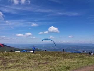 Fototapeta na wymiar Paraglide on mountain top. Hiking mountains to paraglide.