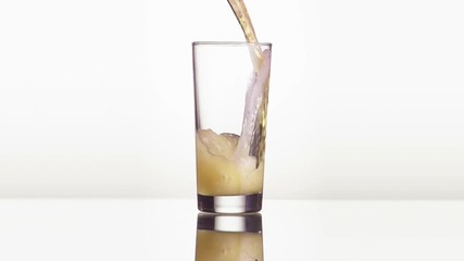 Close up shot of a beer mug being filled with beer. Slow Motion.