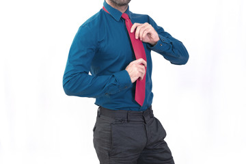 Man adjusting a red tie 