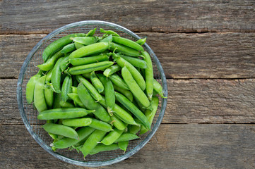 pea pods on wooden surface