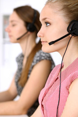 Call center. Focus on beautiful woman in headset