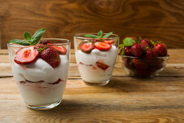Strawberries cream cheese dessert on wooden background