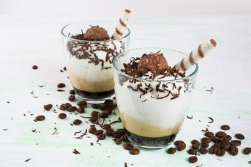 Chocolate cocktail with whipped cream on light green background