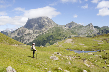 woman in front of a lake in the middle of the mountains in France