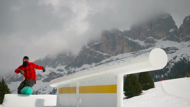 snowboard freestyle slow motion,snowboarder jumping sliding on tube