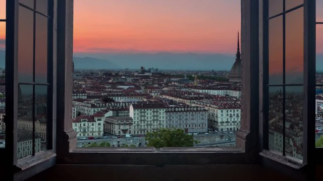 turin skyline time lapse from day to night seen from a window