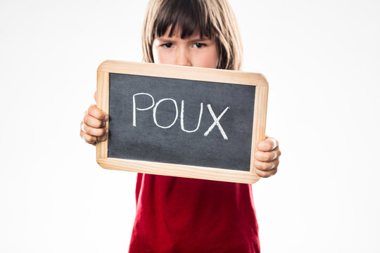 determined young boy with shield against head lice, French poux