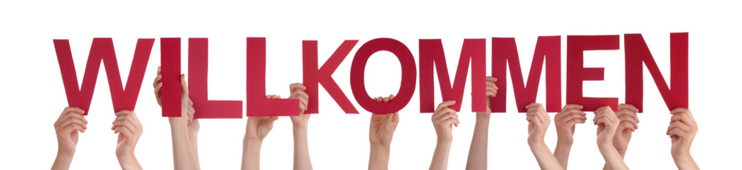 People Holding Straight German Word Willkommen Means Welcome