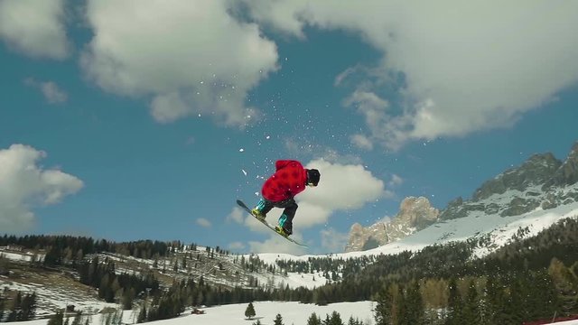 snowboard slow motion,snowboarder jumping spinning backside