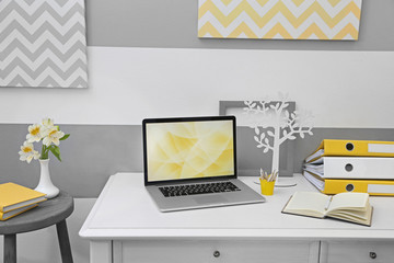Stylish workplace with laptop at home