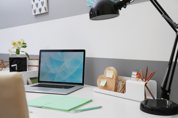 Stylish workplace with laptop at home