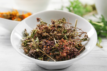 Natural flower and herb selection in ceramic bowl, close up