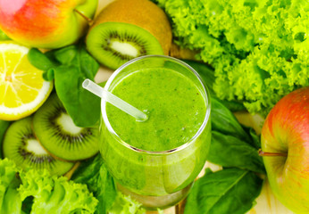 Healthy green smoothie with spinach, kiwi, apples, salad and mint in glass