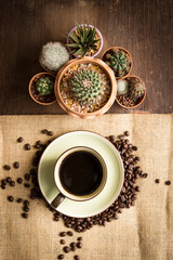 Coffee cup and coffee beans top view on wooden table background