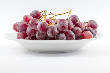 Red grapes on a white background.