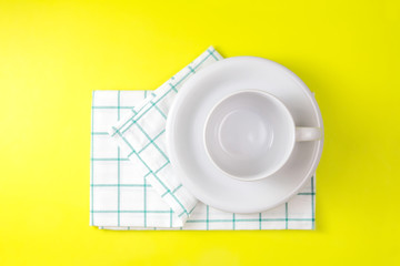 top view of empty white coffee or tea cup with towel 